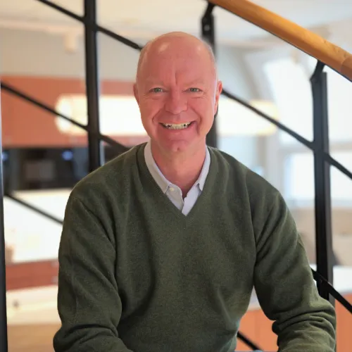 Richard Wiegmann sitting in the stairs at the office.